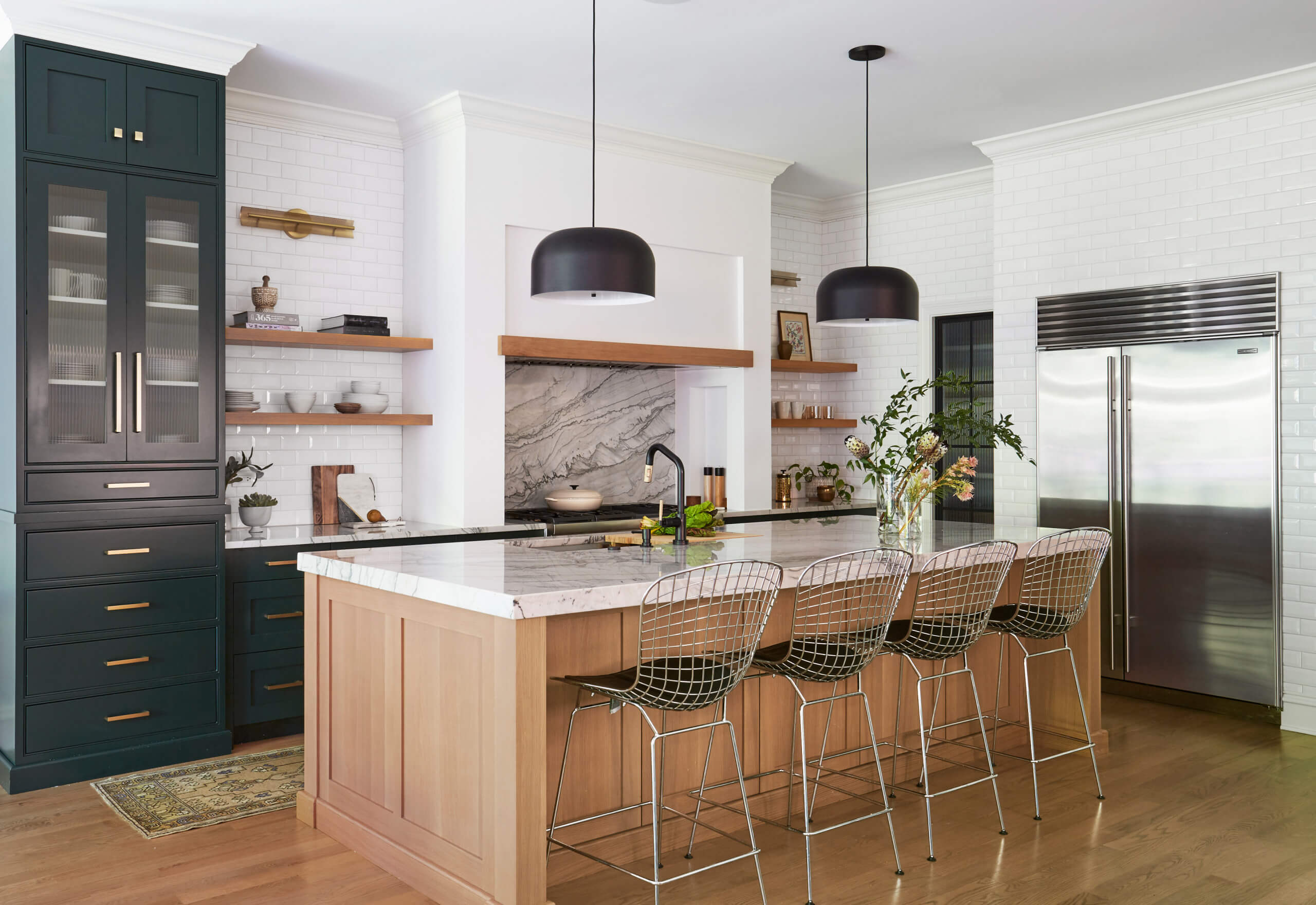 Open kitchen with island and dark green cabinetry