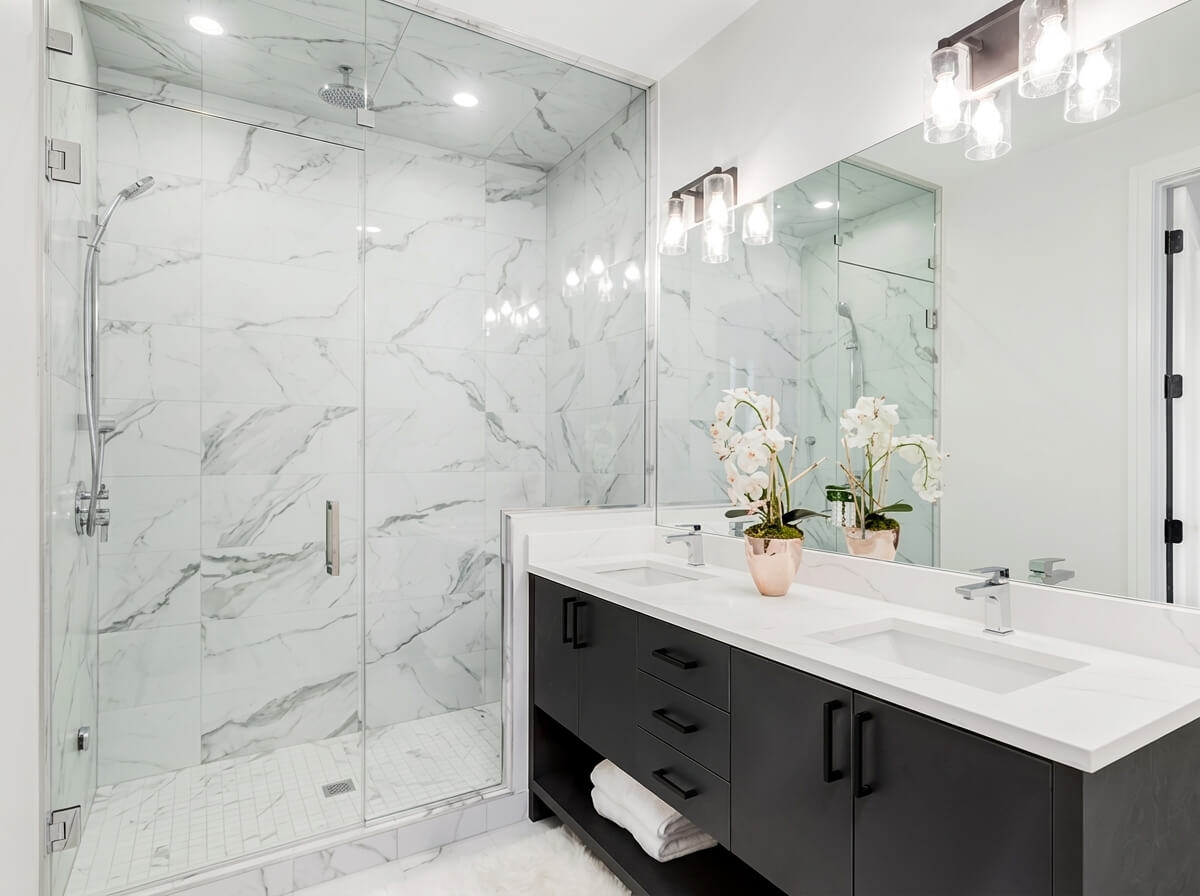 Renovated bathroom with wood-framed mirror